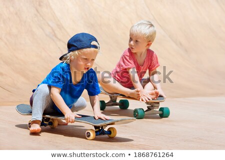 Foto stock: Portrait Of Happy Family Sitting On Skate Board