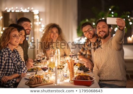 Foto stock: Happy Friends Taking Selfie By Smartphone At Home