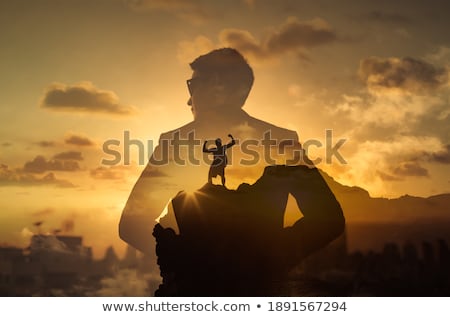 Stock photo: Businessman On The Top Of A City Achieving His Goal