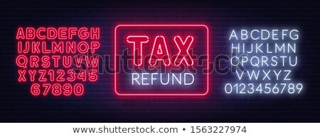 Stok fotoğraf: Tax Refund Neon Sign On Dark Background