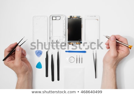 Foto stock: Disassembled Mobile Phone And Tools