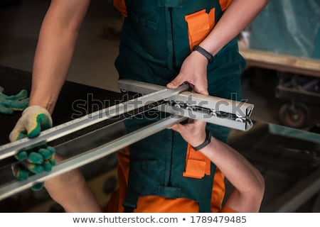 Stock photo: Worker Cutting The Surface Of Glass Mirror