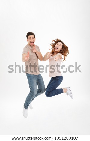 Stock photo: Cheerful Young Couple Jumping