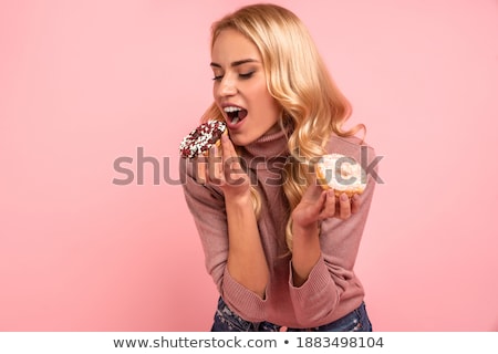 Stok fotoğraf: Hungry Young Woman Isolated Over Pink Wall Background Holding Chocolate And Apple