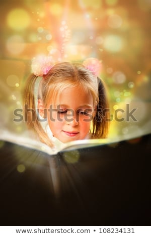 Stockfoto: Image Of Smart Child Reading Interesting Book In Classroom