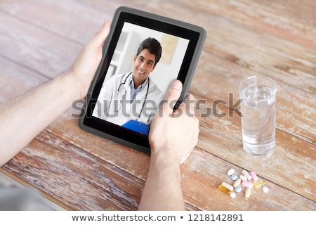 Stok fotoğraf: Close Up Of Hands With Tablet Pc Pills And Water