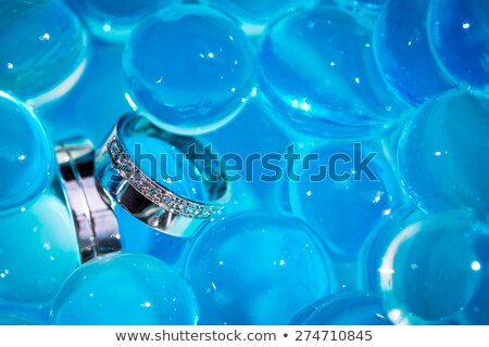 Foto stock: Wedding Rings Amid Blue Balls