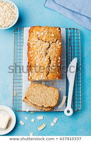 Stok fotoğraf: Healthy Vegan Oat And Coconut Loaf Bread Cake On A Cooling Rack Blue Stone Background Top View