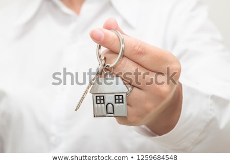 Сток-фото: Female Real Estate Agent With House Model Key Ring
