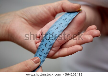 Foto stock: Close Up Of Hands With Tape Measuring Baby Foot