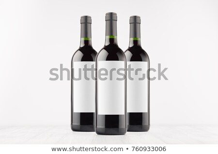 Stockfoto: Three Dark Wine Bottles With Blank White Labels On White Wooden Board Mock Up