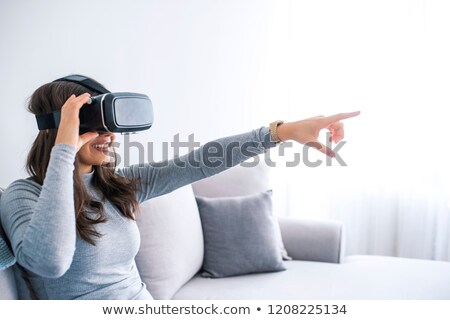 [[stock_photo]]: Happy Smiling Young Woman Playing Game While Getting Experience