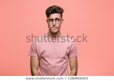Stok fotoğraf: Portrait Of A Confused Young Casual Man