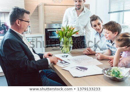Stok fotoğraf: Family Planning Their Kitchen With Experienced Expert In The Shop