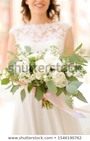 Foto stock: Young Pretty Bride With Bridal Bouquet Indoors