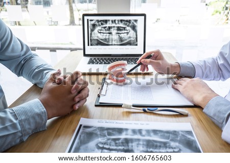 Сток-фото: Dentist And Patient Discussing Dental Treatment