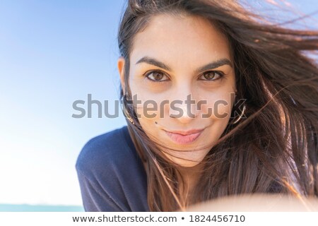 Zdjęcia stock: Beautiful Young Woman Looking At Camera With Flowers