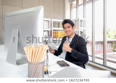 Stockfoto: Portrait Of Smiling Businessman Holding Tablet And Making Ok Sig