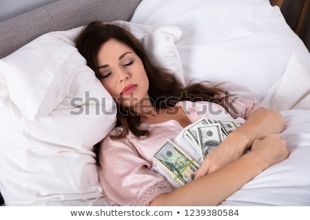 Stock fotó: Woman Sleeping With Bundle Of Currency Notes