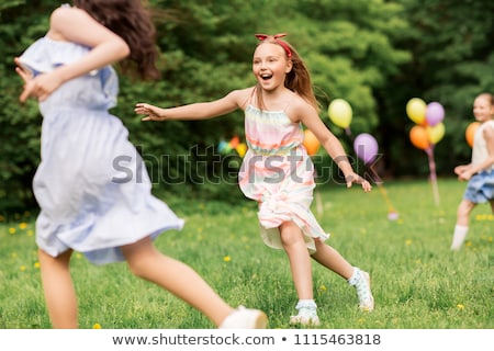 Stockfoto: Happy Kids Playing Tag Game At Birthday Party