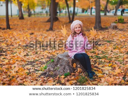 ストックフォト: Stylish Child Girl 5 6 Year Old Wearing Trendy Pink Coat In Autumn Park Looking At Camera Autumn S