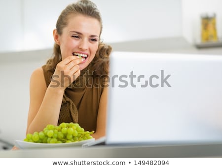 Stock foto: Woman Eating Grapes