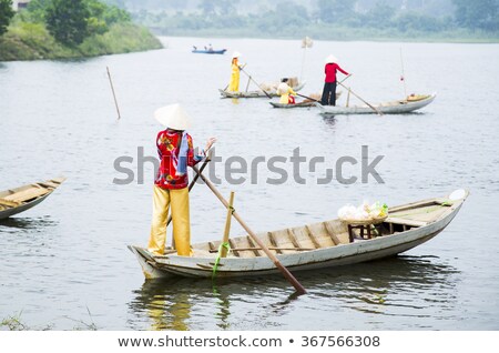 [[stock_photo]]: Woman On Wooden Boat In River In Vietnam Asia