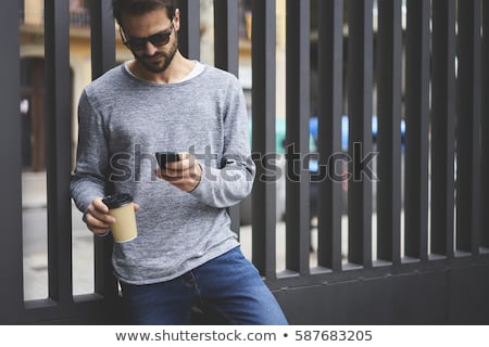 ストックフォト: Man With Smartphone And Coffee At Clothing Store