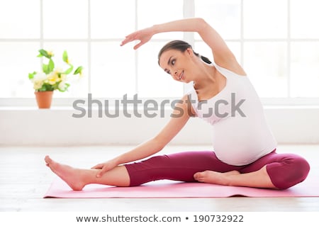 Stockfoto: Pregnant Young Women Stretching And Exercising