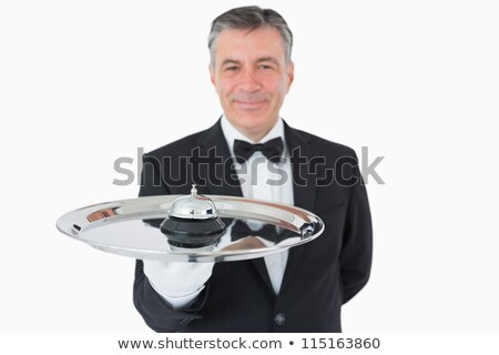 Foto stock: Man Holding A Silver Tray With A Hotel Bell On It