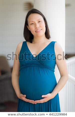 Stok fotoğraf: Young Pregnant Chinese Woman Portrait In Park