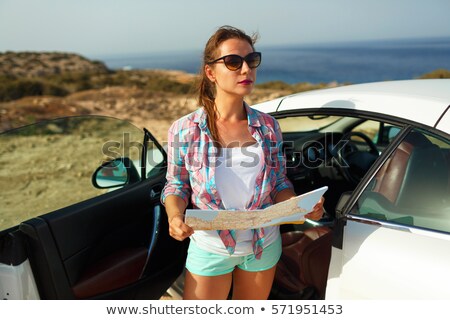 Foto stock: Young Pretty Woman See The Map Near The Cabriolet