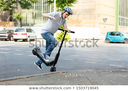 Foto d'archivio: Man Falling From E Scooter