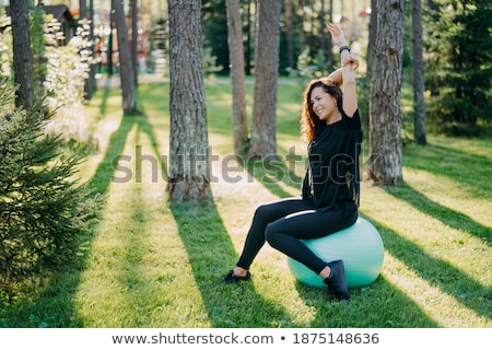 Foto stock: Young Female Athlete Excercising And Stretching In A Park