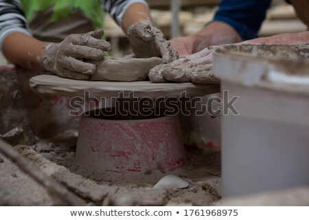 Сток-фото: Male Potter Assisting Girl In Molding A Clay