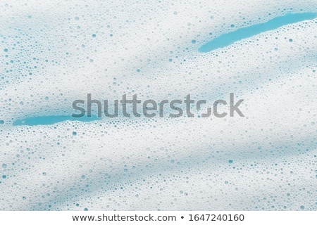 Foto d'archivio: Soap Foam On A Blue Background
