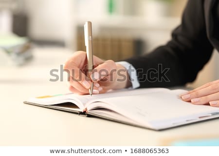 Сток-фото: Close Up Of A Businesswomans Hand Writing Note In Diary