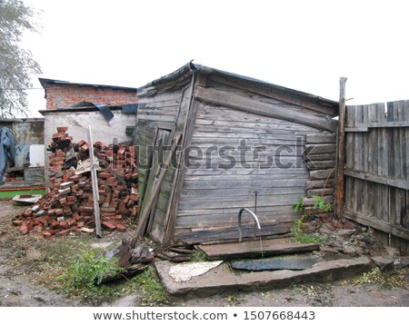 [[stock_photo]]: Old Rickety Wooden Fence With Broken Areas