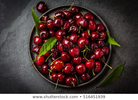 Foto stock: Black Cherries In A Black Bowl Top View Copy Space