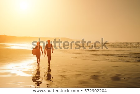 [[stock_photo]]: Woman Leaving The With Bodyboard After Surfing