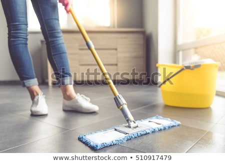 Foto d'archivio: Woman Or Housewife With Mop Cleaning Floor At Home