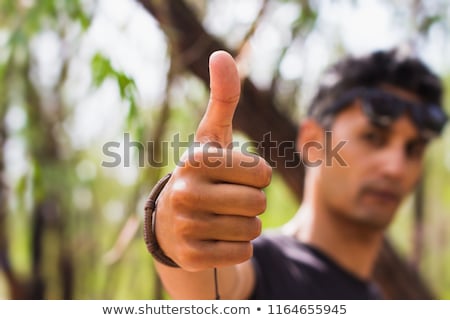 [[stock_photo]]: Closeup Portrait Of A Male Hand Showing Thumbs Up Isolated On A White Background