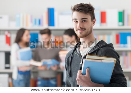Stock fotó: Portrait Of An University Student Holding Books And Smiling