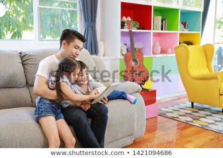 Сток-фото: Mom Teaching A Daughter How To Use A Tablet