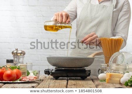 Stock photo: Chef Pours Olive Oil