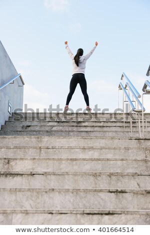 [[stock_photo]]: Successful Athlete Raising Arms After Running On Urban Stairs