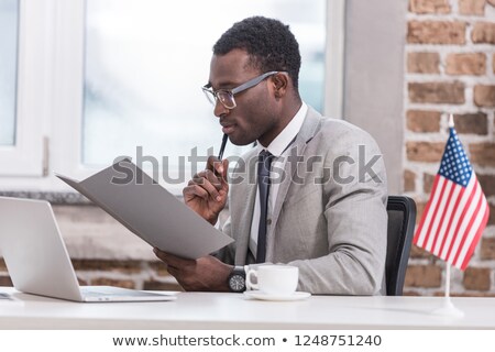 [[stock_photo]]: African American Businessman Sitting At The Computer In Startup Office