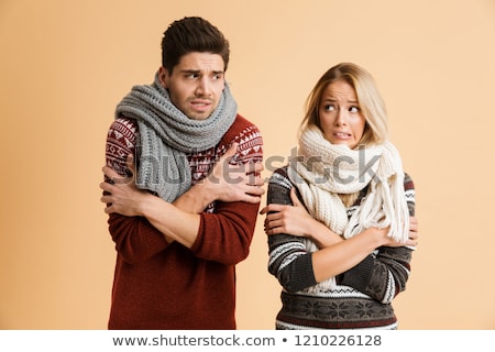 Foto d'archivio: Portrait Of A Frozen Young Couple Dressed In Sweaters