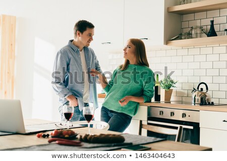 Stockfoto: Serious Young Casual Couple Standing With Hands In Pockets