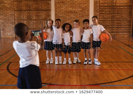 Stock fotó: Rear View Of Schoolboy Clicking Photo With Mobile Phone Of His Friends At Basketball Court In School